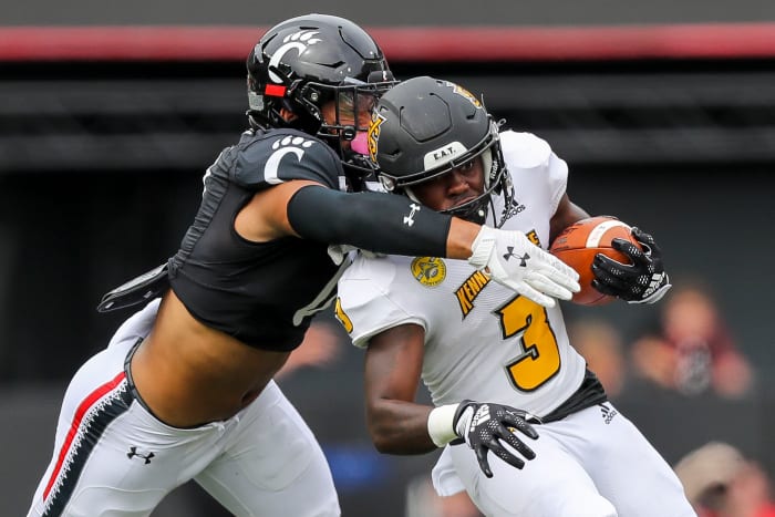 Sep 10, 2022; Cincinnati, Ohio, USA; Kennesaw State Owls running back Nykeem Farrow (3) runs with the ball against Cincinnati Bearcats linebacker Ivan Pace Jr. (0) in the first half at Nippert Stadium. Mandatory Credit: Katie Stratman-USA TODAY Sports